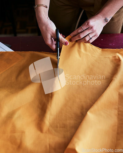 Image of Lets give this piece of fabric some life. Cropped shot of an unrecognizable fashion designer cutting fabric.