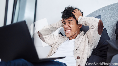 Image of Just when you thought 2020 couldnt get any crazier. Shot of a young man looking shocked while using a laptop on his bed at home.