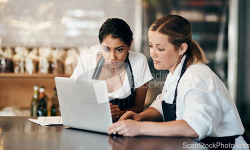 Image of Partner up with someone who matches your hustle. Shot of two women using a laptop together while working in a cafe.