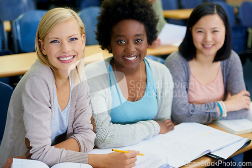 Image of Education is the key to our futures. Shot of female university students sitting in an exam room.