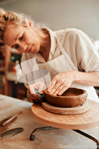 Image of I love working with clay. Cropped shot of a woman shaping a clay pot in her workshop.