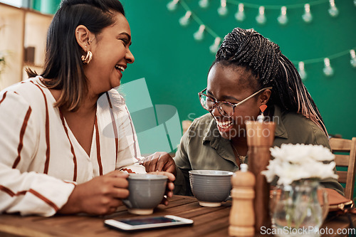 Image of Life is short. Fill it with love and laughter. Shot of two young women chatting at a cafe.