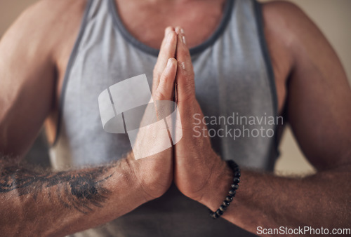 Image of Taking the time to be grateful. Cropped shot of an unrecognizable man sitting with his palms together while meditating indoors.