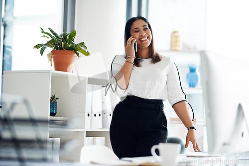 Image of I can meet up with you tomorrow. Shot of a young businesswoman talking on a cellphone in an office.