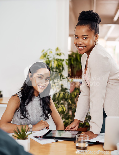 Image of Theres an app to assist our every need. Portrait of two businesswomen working together on a digital tablet in an office.