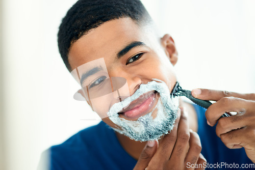 Image of Hair removal, mirror and shaving with man in bathroom for grooming, morning routine and cleaning. Skincare, razor and self care with face of male person at home for facial, beard and hygiene