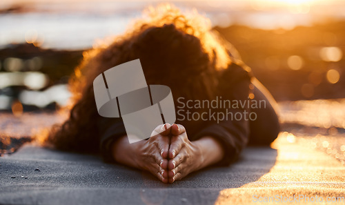 Image of Woman, beach and sunset with yoga, balasana and stretching for health, fitness and mindfulness on holiday. Girl, workout and zen meditation for peace, mindset and nature with chakra balance by ocean