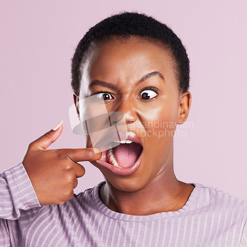 Image of Woman, squint and face in pink studio background with closeup in africa with meme. Female person, portrait and squinting eyes for comedy expression with joy and goofy girl with weird or crazy look.