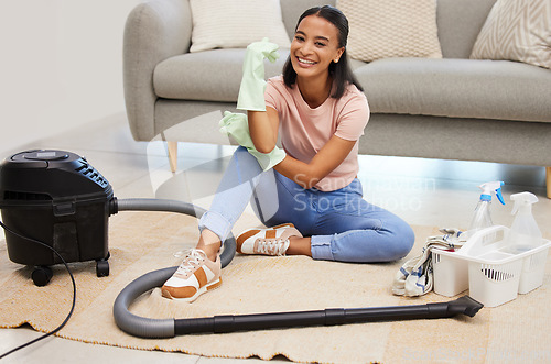 Image of Vacuum, home and woman portrait with a smile from spring cleaning and tidy living room. Lounge, floor and young female person with happiness from clean rug, housekeeping and maid work on carpet