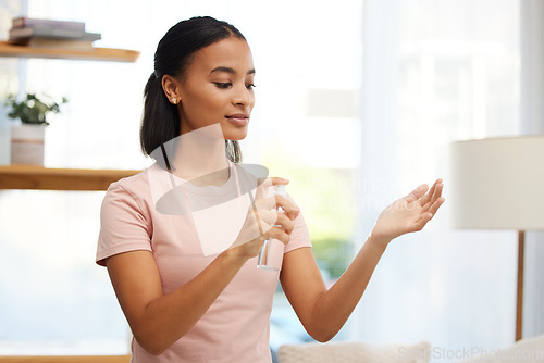 Image of Hand, sanitizer and woman with spray bottle at home for hygiene, protect or antibacterial disinfectant. Cleaning, hands and woman with product for safety from bacteria, germs or illness in her house