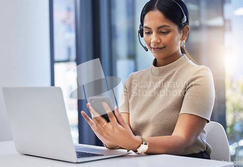 Image of Call center, woman and typing on smartphone at laptop in office of customer service, CRM consulting and help desk. Telemarketing, female consultant and mobile communication at computer on telecom app