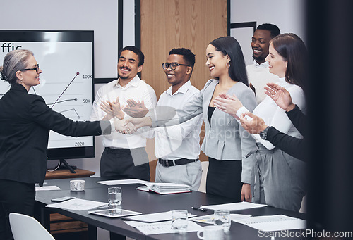 Image of Business people, handshake and applause in meeting for hiring, teamwork or partnership agreement at office. Group shaking hands or clapping in team recruiting success or corporate growth at workplace