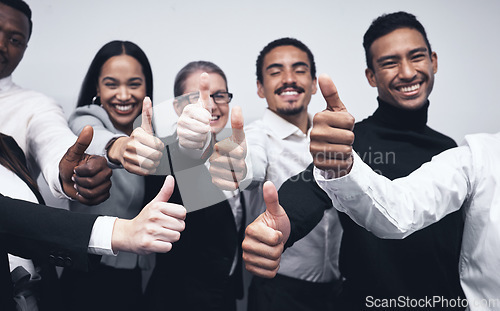 Image of Happy, business people and thumbs up for winning, success or team approval together at office. Group of employee workers with smile showing thumb emoji, yes sign or like for teamwork, win or goals