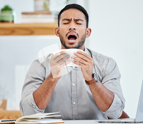 Image of Sneeze, allergies and business man in office with tissue for sick, illness and healthcare. Allergy, flu and disease with corporate male employee blowing nose at desk for virus, sneezing and hayfever