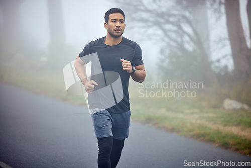 Image of Man, fitness and running on road in nature for cardio workout, exercise or training outdoors. Fit, active or athlete male person or runner exercising on street asphalt in run for healthy wellness