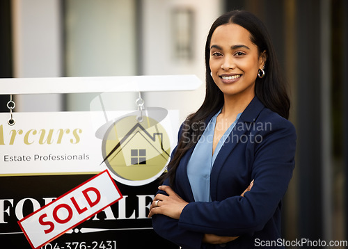 Image of Sold, real estate and woman in portrait with arms crossed for home investment, property sale and agency. Happy face of agent, realtor or biracial person with house sign or board in business success