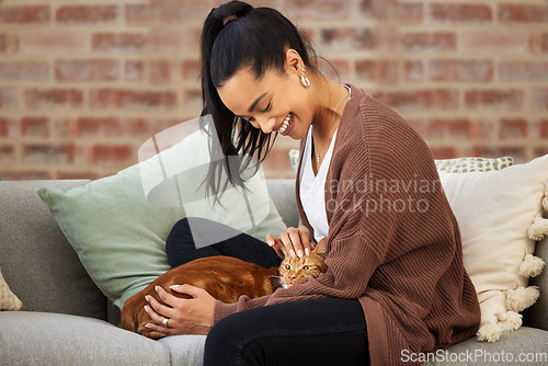 Image of Love, woman with her cat and on a sofa in living room of her home sitting. Animal care or support, quality or bonding time and happy female person pet her kitten on a couch together at her house