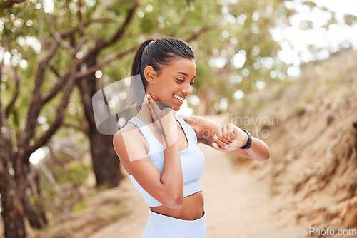 Image of Sports, running and woman checking her heart rate while training for a race, competition or marathon. Fitness, exercise and female athlete runner with time and pulse during an outdoor cardio workout.