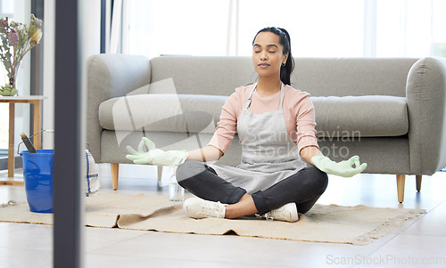 Image of Living room, clean and woman with yoga, lotus and breathing exercise on a floor during housework at home. Cleaning, break and woman in meditation in lounge for balance, zen and mental health wellness