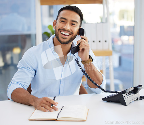 Image of Consultant, businessman writing in a notebook and on a phone at his desk at work. Customer support or service, contact and smiling male person using telephone with writing book at his workplace