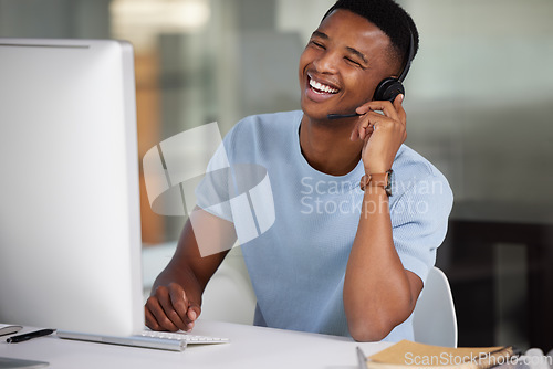 Image of Call center, laughing man and computer for customer service call, support and crm website. Happy black male person, consultant or agent with a headset for help, sales and telemarketing with internet