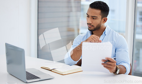 Image of Paperwork, laptop and business man analyst working on project in office workplace. Computer, documents and serious male professional analyze report for finance, planning strategy and reading email.