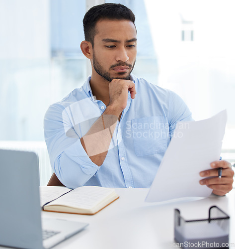 Image of Reading, documents and business man thinking, problem solving or looking for solution in office workplace. Computer, paperwork and serious male professional read report, planning or focus on contract