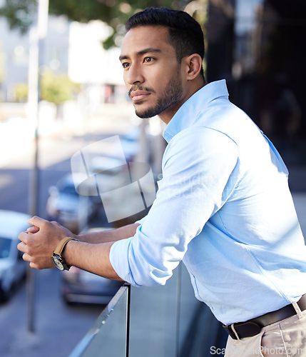 Image of Thinking, vision and a business man on the balcony of his office looking at the city for inspiration. Future, idea and mindset with a young male employee contemplating a decision in an urban town