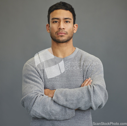 Image of Serious, arms crossed and portrait of man in studio for attitude, moody and focus. Stress, sad and problem with face of male model on grey background for mental health, sadness and disappointed