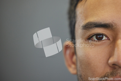 Image of Mockup, portrait and half eyes of a man isolated on a grey background in studio. Serious, Asian and closeup face of a person with space for expression, looking handsome and a young eye on a backdrop