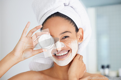 Image of Portrait, happy woman and towel with mask, jar and skincare product in bathroom for face, cosmetics and self care. Clean shower, beauty and female person with container, facial cream and dermatology
