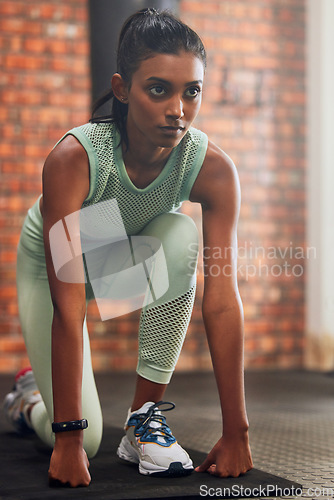 Image of Ready, fitness or serious woman in gym with determination, resilience or confidence to start workout. Beginning, sports athlete or confident healthy girl in body exercise training session on mat