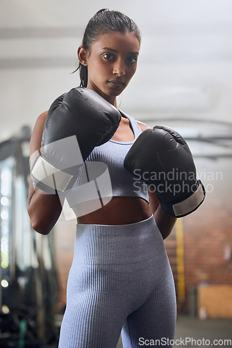 Image of Young indian woman, boxing gym and portrait in gloves for fight, training or workout for health. Athlete girl, box club and exercise for conflict, performance and power with wellness, sport and goals