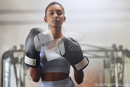 Image of Fitness, gym or portrait of girl boxer in training, exercise or workout with a warrior mindset or wellness. Sports, motivation or healthy woman with speed, fast or powerful punch in boxing gloves