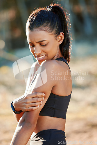 Image of Fitness, runner or girl with arm injury in fitness training, workout emergency or running exercise in park. Bruised, shoulder pains or tired woman athlete with bad triceps muscles accident in nature