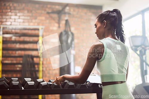 Image of Personal trainer, gym or woman checking dumbbells or writing weights info for inspection checklist. Fitness business, girl or entrepreneur with inventory documents for training equipment monitoring