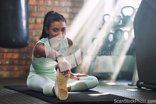 Image of Gym, fitness or portrait of happy woman stretching legs for a workout or body movement for wellness. Smile, athlete or healthy girl smiling in exercise training warm up for flexibility or mobility