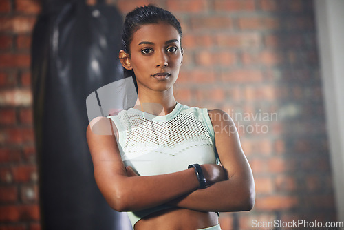 Image of Woman, fitness and serious face in portrait with athlete in gym, arms crossed and determination with confidence. Mockup space, female person in exercise studio and active with health, sport and tough