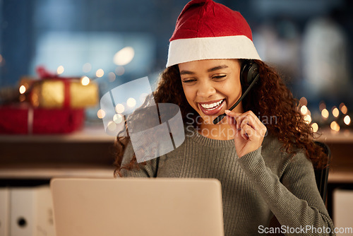 Image of Christmas hat, call center and female agent working overtime in office at night in festive. Laptop, contact us and woman customer support consultant with online crm consultation with headset on xmas.