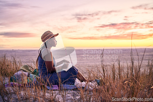 Image of Black woman, relax and book on beach in sunset with diary or journal for vacation in nature outdoors. African female person relaxing on ocean coast with notebook in morning sunrise and holiday travel