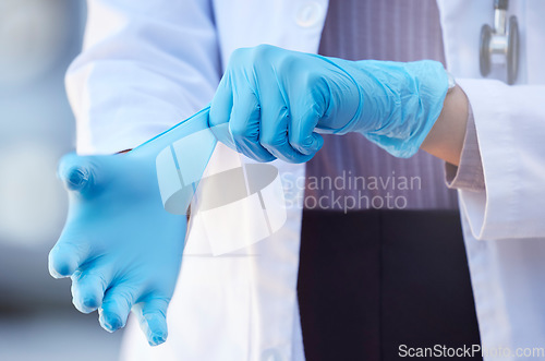 Image of Healthcare, hand of doctor and surgery with surgical gloves for protection at a hospital. Procedure or ppe, health and hands of a nurse or surgeon to perform an operation at a medical clinic