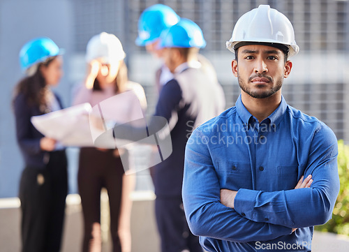 Image of Businessman, portrait and architect with arms crossed in leadership, management or team construction on site. Confident and serious man, engineer or manager with hard hat for industrial architecture