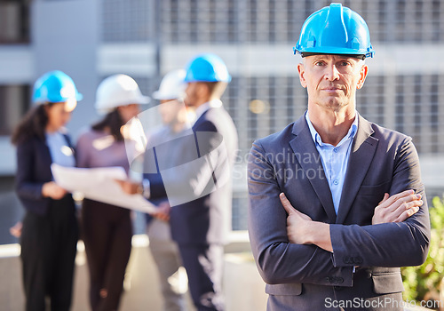 Image of Businessman, portrait and architect with arms crossed in project management, leadership or construction on site. Confident man, engineer or manager with hard hat and team for industrial architecture