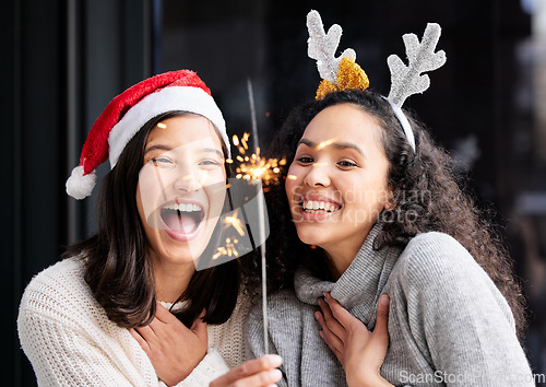 Image of Women friends, Christmas and sparkle light with smile, home and celebration of festive holiday. Girl, woman and excited with fireworks, celebrate and happiness on vacation, laughing and xmas bonding