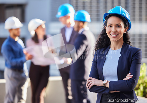 Image of Happy woman, portrait and architect in construction, leadership or team management with arms crossed on site. Confident female person, engineer or manager with hard hat for industrial architecture