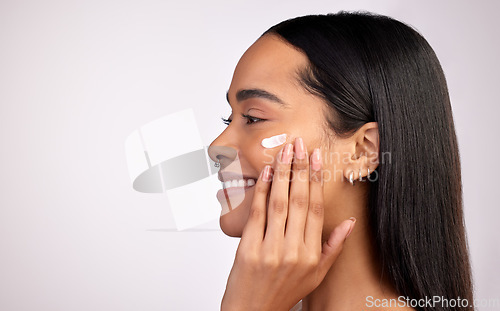 Image of Happy woman, face and cream on mockup for skincare, beauty or cosmetics against a grey studio background. Female person smiling with lotion, creme or moisturizer for facial treatment on mock up space