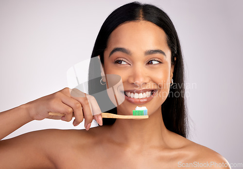 Image of Happy woman, toothbrush and teeth for dental, cleaning or hygiene against a grey studio background. Face of female person with bamboo tooth brush for clean oral, mouth and gum healthcare or wellness