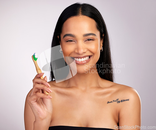 Image of Happy woman, portrait and teeth with toothbrush for dental, cleaning or hygiene against a grey studio background. Face of female person with bamboo tooth brush in clean oral, mouth and gum healthcare