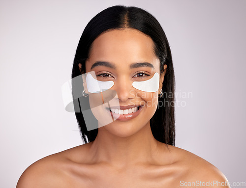 Image of Happy woman, portrait and eye patches for skincare, collagen or dermatology against a grey studio background. Face of female person or model smiling for beauty cosmetics, mask or facial treatment