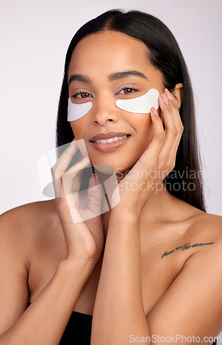 Image of Happy woman, portrait and eye mask for skincare, collagen or dermatology against a grey studio background. Face of female person or model smiling for beauty cosmetics, patches or facial treatment